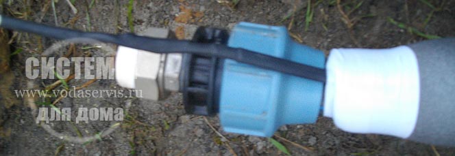 утепленный трубопровод с греющим кабелем и концевые фитинги на водопроводной трубе